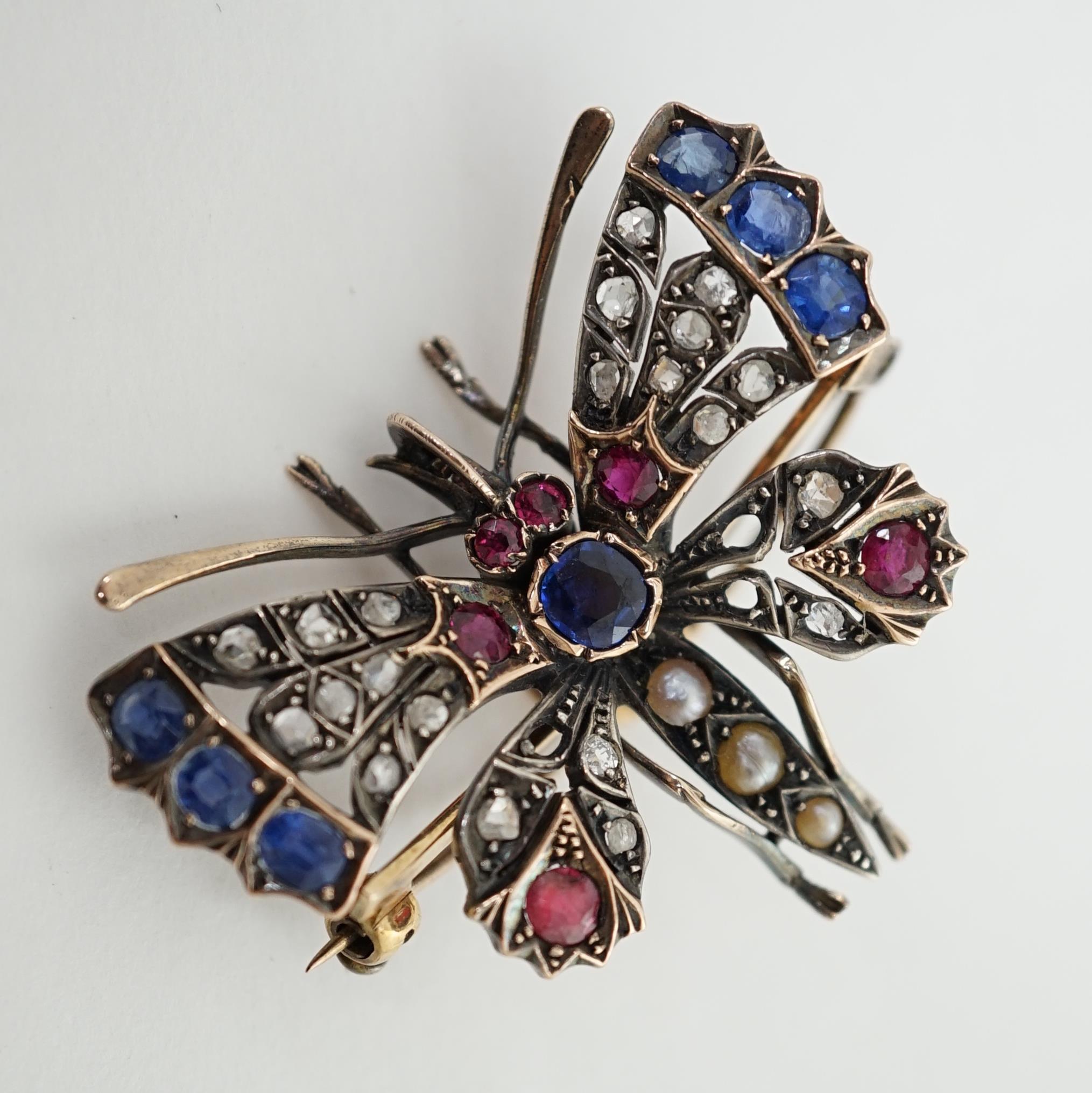 A Victorian gold, diamond, sapphire, ruby and split pearl cluster set butterfly brooch